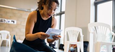 Actor reading a letter excitedly