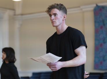 A student holding a script in class