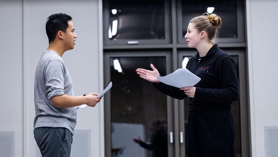 Two LAMDA short course participants holding scripts in a rehearsal room