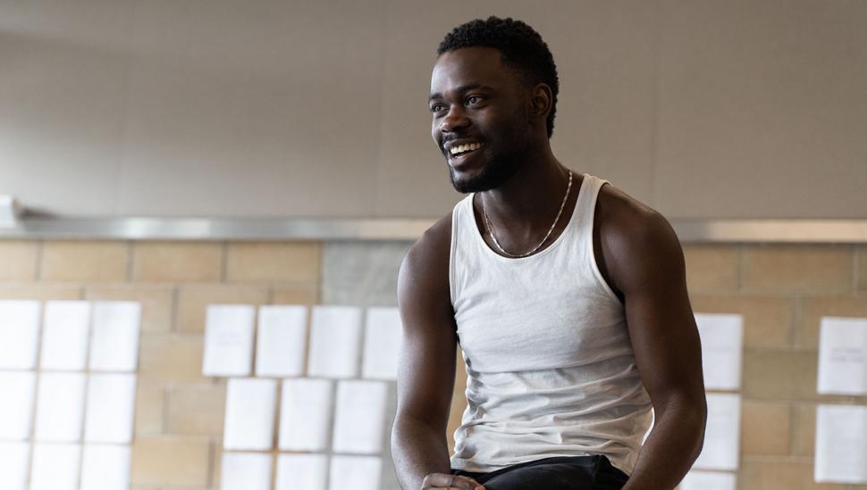 A student smiling in a rehearsal room