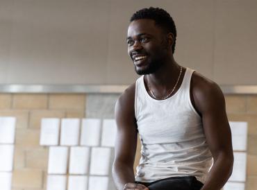 A student smiling in a rehearsal room
