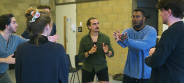 Still from The L's episode 3 featuring the cohort playing a drama game as part of an intimacy workshop.